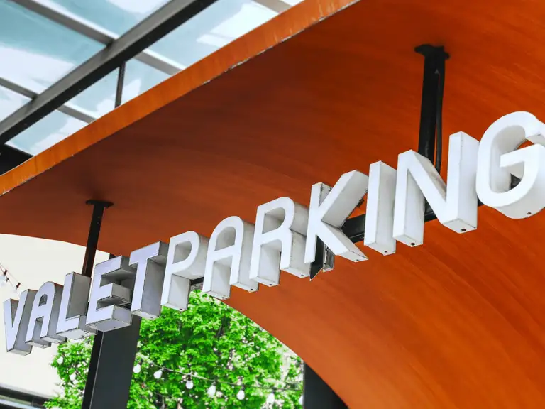Illuminated channel-letter signage on a parking structure