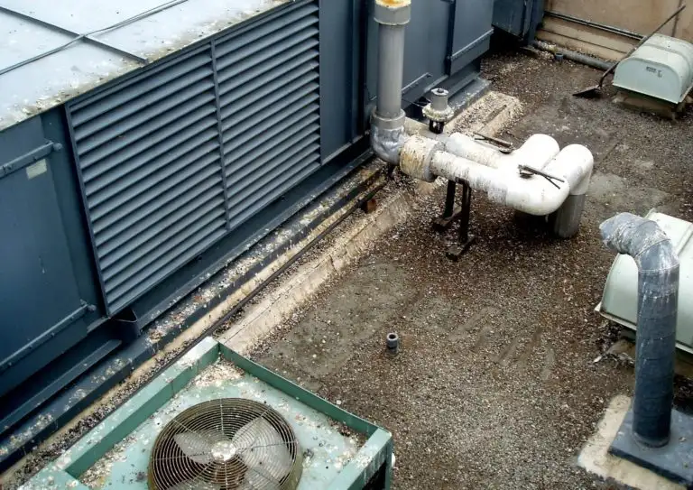 Heavy pest bird damage and droppings on a rooftop HVAC unit